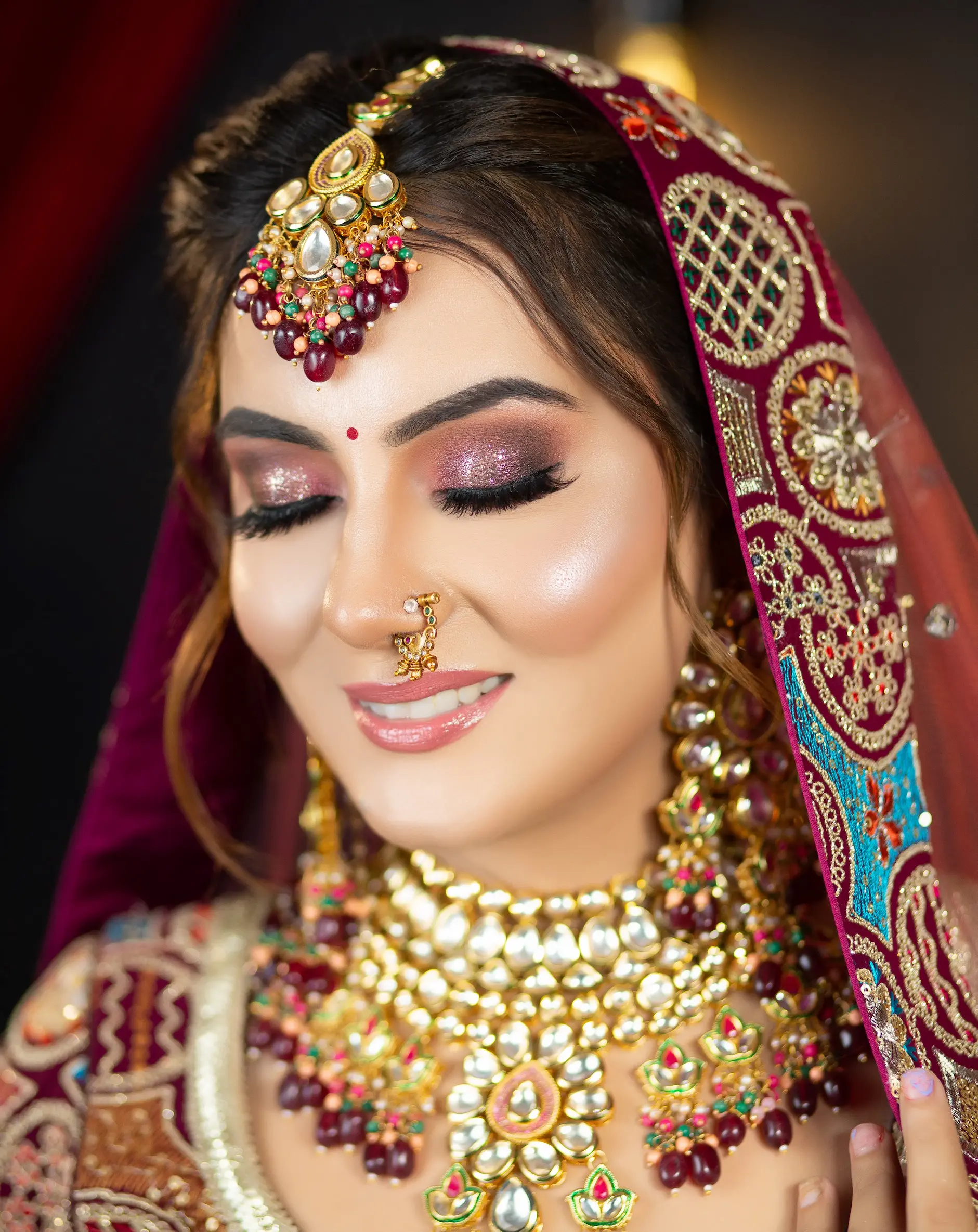 Bride in red and gold bridal attire with polished bridal makeup at Rush Salon, Surat