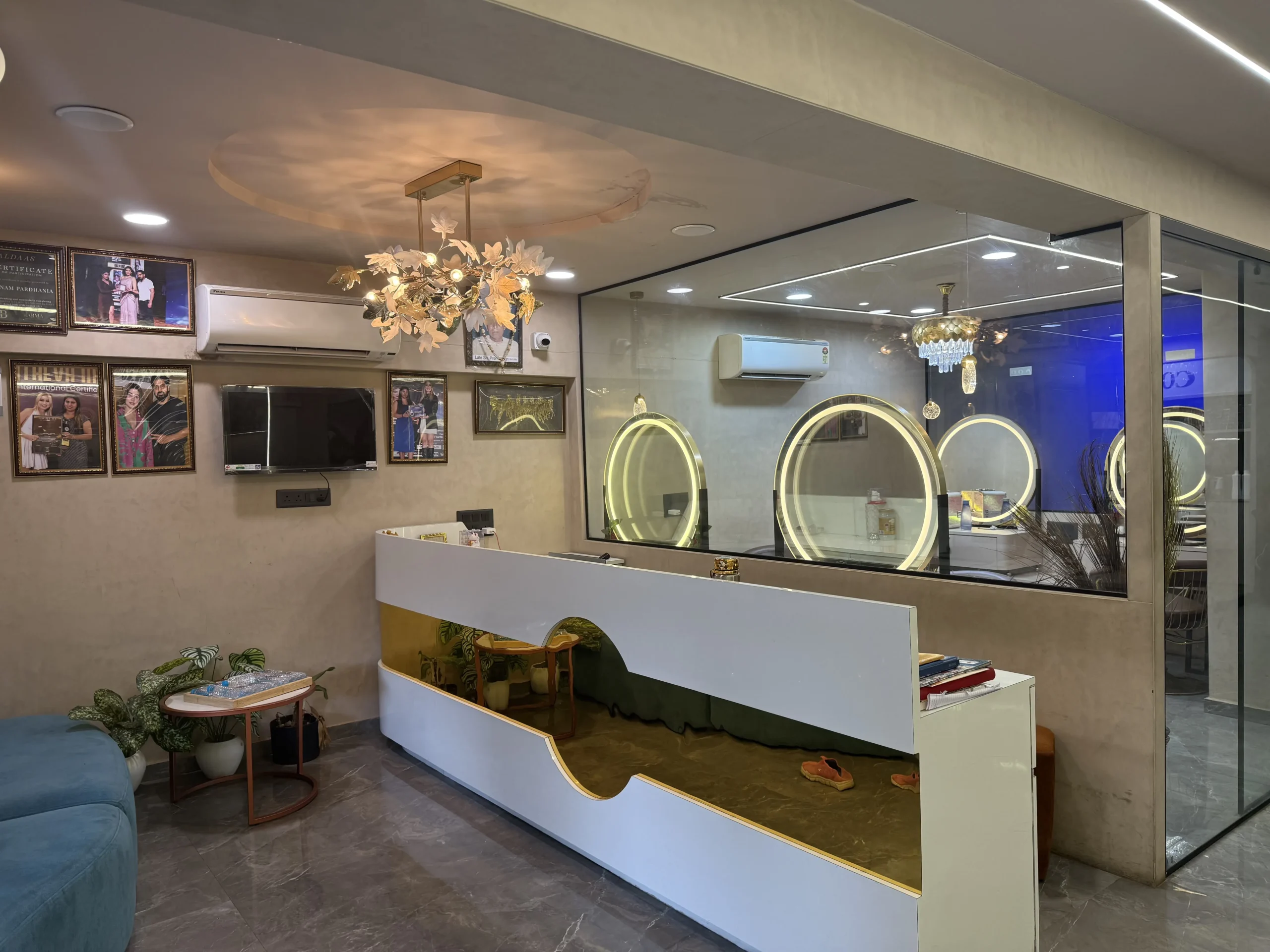 Gold arch mirrors and seating in the ladies section at Rush Salon, a ladies salon in Surat
