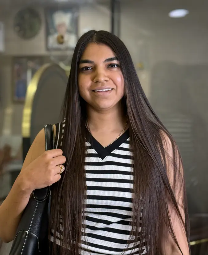 Stylist shaping long hair with scissors at Rush Salon, Surat