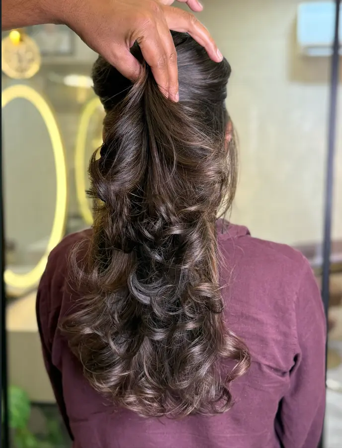 Stylist cutting a client's hair at Rush Salon, Surat