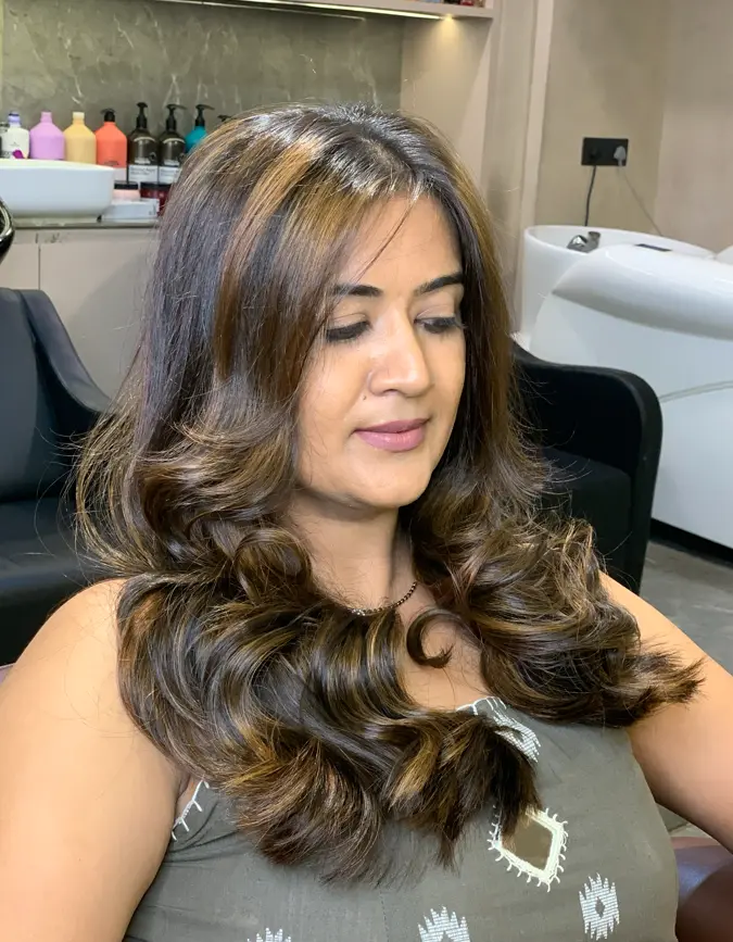 Stylist applying hair colour with foils at Rush Salon, Surat
