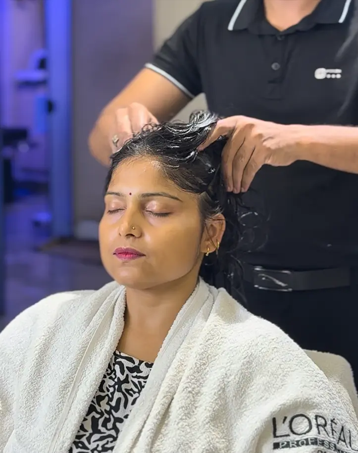 Conditioning care applied to freshly coloured glossy hair at Rush Salon, Surat