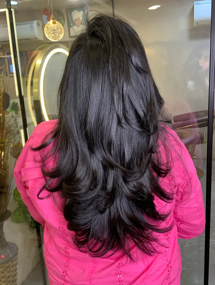 Stylist discussing a completely transformed new hairstyle with a client at Rush Salon, Surat