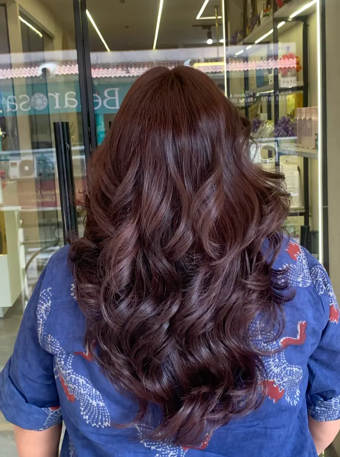 Hair styling vanity with gold arch mirror and professional tools at Rush Salon, Surat